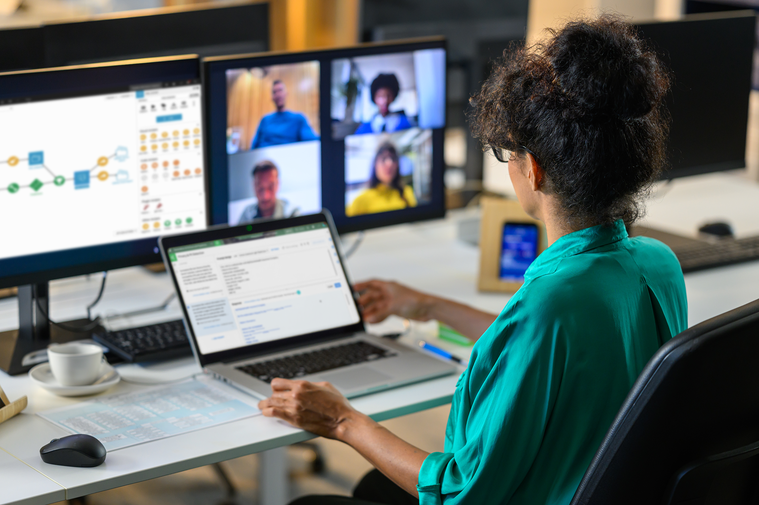 woman sitting at a desk using Dataiku for all enterprise AI needs including analytics, developing machine learning models, and building AI agents